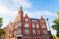 The building of the town hall from 1904. Red brick facade. Beautiful blue sky. The richly decorated facade of the tenement house. Royalty Free Stock Photo